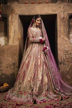 a woman in a bridal gown poses for the camera