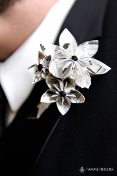 a man in a tuxedo wearing a flower brooch