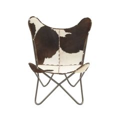 a black and white cow hide chair on a metal frame with two holes in the back