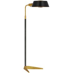 a floor lamp with a black shade on the top and gold trimming around it