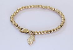 "Simple. Chic. Minimalist™ Super cute beaded bracelet for your little daughter. Also a great gift! Tiny 14k gold filled beads (3mm) and a stunning 14K gold plated Hamsa Hand charm are strung on a sturdy 14K gold filled Rollo (superb quality) chain. Bracelet available in the following sizes: 4\"-4.5\" (4\" with half-an-inch of extension chain) 0-1 years old 4.5\"-5\" (4.5\" with half-an-inch of extension chain) 1-2 years old 5\"-5.5\" (5\" with half-an-inch of extension chain) 2-5 years old 5.5\" Gold Beads Bracelet, Girl Bracelet, Hamsa Bracelet, Baby Bracelet, Gold Jewelry Earrings, Gold Bead Bracelets, Rose Gold Jewelry, Handmade Gold