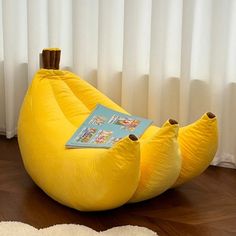 two yellow bean bags sitting on top of a wooden floor