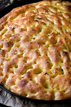 a close up of a pie in a pan on top of a cloth covered table