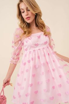 This charming pink dress is designed with a fun flair! Adorable glitter heart patches are sprinkled all over for a touch of magic! Crafted from a lightweight tulle mesh material in a flattering babydoll silhouette and a mini hem length. Featuring a square neckline, elastic sleeved and a zipped per back closure. This darling dress is perfect for any occasion! Glitter heart patches Lightweight Square Neckline Elastic shoulder Tulle 3/4th sleeves Zipper clousure 100 Poly True to size Size Guide: SM Cute Party Dress With Sweetheart Neckline, Spring Princess Dress With Sweetheart Neckline, Pink Playful Short Sleeve Mini Dress, Pink Playful Mini Dress With Short Sleeves, Playful Pink Mini Dress With Short Sleeves, Cute Pink Dress With Sweetheart Neckline, Cute Mini Dress With Sweetheart Neckline For Party, Playful Mini Dress For Spring Party, Playful Spring Mini Dress For Parties