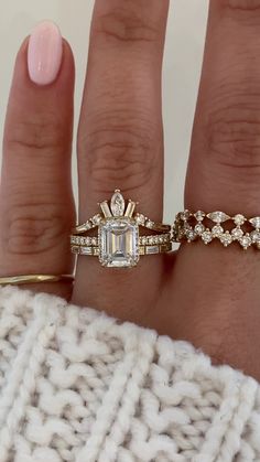 Samanthina features a striking emerald cut diamond sitting atop the band. We then sprinkled some diamonds along the ring's gallery to give it extra sparkle and a peek-a-boo halo. To add to her magnificence she exhibits pave half way down her band. Islet's curved band holds a marquise diamond as the center piece accompanied by two baguette cuts on either side with round cut sparklers finishing off the piece. Iva is the perfect companion that effortlessly stacks to create a harmonious and elegant Three Stone Emerald Cut Engagement Ring And Wedding Band, Curved Wedding Band With Emerald Cut Engagement Ring, Emerald Cut Wedding Rings Set, Engagement Rings Eternity Band, Wedding Bands With Emerald Engagement Ring, Wedding Bands That Go With Emerald Cut, Wedding Bands To Go With Emerald Cut, Engagement Ring Inspo Gold, Baguette Halo