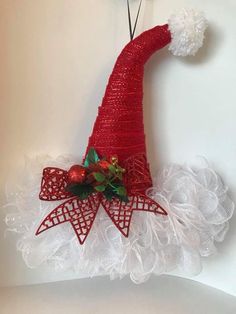 a red and white christmas decoration hanging on a wall