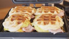 four waffles with ham and cheese on them