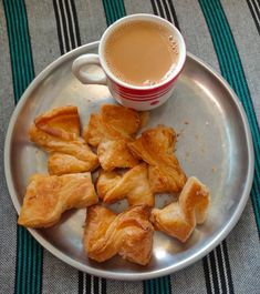 a plate with some croissants and a cup of coffee