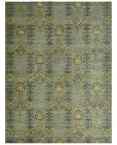 a green rug with an intricate design on the front and back side, in various colors