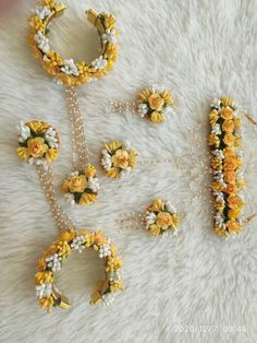 flowers and pearls are arranged in the shape of letters