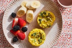 a paper plate topped with muffins and fruit next to a cup of coffee