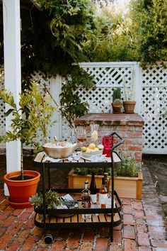 an outdoor bar cart with food and drinks on it