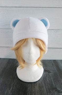 a white hat with blue ears on top of a mannequin's head