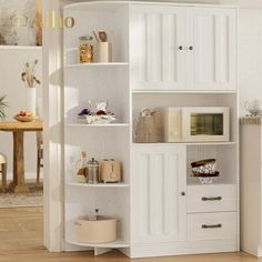 a white bookcase with shelves and drawers in a room next to a dining table