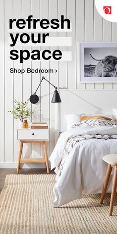 a bed room with a neatly made bed next to a white wall and wooden floors