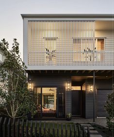 a modern house with two balconies on the second floor