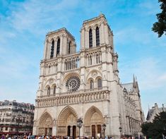 a large cathedral with many people walking around it and onlookers in the foreground