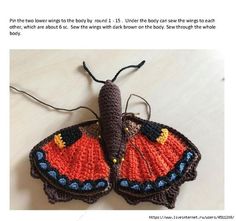 a crocheted butterfly sitting on top of a table