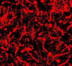 red and black paint splattered on a black background with white dots in the center