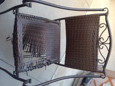 two brown wicker chairs sitting next to each other on a metal frame and floor