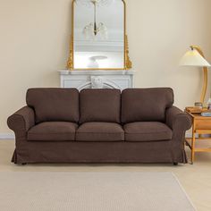 a living room with a couch, table and mirror