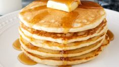 a stack of pancakes with syrup and butter on top