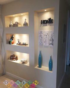 some shelves with vases and pictures on them