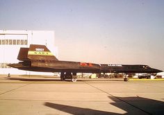 an air force jet sitting on top of an airport tarmac next to a building