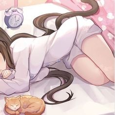 a woman laying on top of a bed next to a cat and an alarm clock