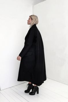 "Premium quality Black woolen coat has an oversize silhouette through the body , crafted in a heavy and thick high quality Italian wool fabric. Calf-length coat is fastened with two knobs. The coat has a unique cut , features big collar, long sleeves and is very stylish. This coat has a horizontal line through the front and back, there are large pockets in front. On one side on the shoulder is a decorative detail. The coat is with viscose lined. This coat is very stylish and unique created by a Black Oversized Long Wool Coat, Chic Long Black Wool Coat, Oversized Black Wool Coat For Fall, Oversized Long Wool Coat For Work, Black Oversized Long Sleeve Pea Coat, Oversized Black Wool Pea Coat, Oversized Black Wool Coat For Winter, Black Oversized Long Outerwear, Oversized Long Black Outerwear