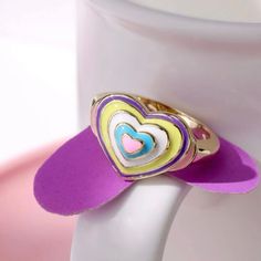 14k Gold Plated 925. Silver, Multi Pastel Colored Rainbow Heart Shaped Ring Size 7 Or 8. Excellent Gift to brighten someone day, week or month! This particular Jewelry piece was solely crafted to add glamour to any wardrobe & style weather contemporary or modern, this unique and elegant piece blends in perfectly!Upgrade your attire, accessorize like a boss, wear on the night out or around the house, this ring is guaranteed to gain attention. *Hypoallergenic, Dermatologist tested, Comes in size 7 Cute Multicolor Rings For Gift, Cute Multicolor Rings For Gifts, Cute Multicolor Rings As Gifts, Playful Heart Jewelry For Valentine's Day, Cute Multicolor Jewelry For Valentine's Day, Cute Multicolor Round Rings, Multicolor Rings For Anniversary Valentine's Day, Sweet Gold Jewelry For Valentine's Day, Multicolor Rings For Anniversary On Valentine's Day