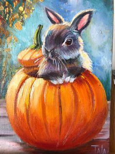 a painting of a rabbit in a pumpkin