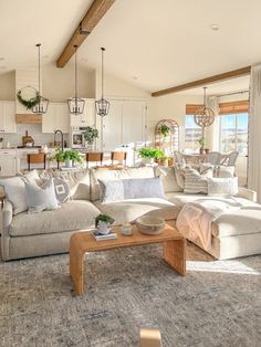 a living room filled with furniture and lots of windows