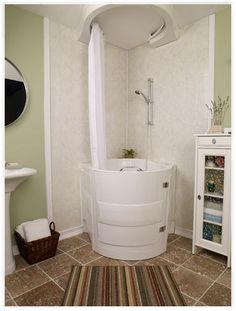 a bathroom with a corner tub and sink in the corner, next to a white cabinet