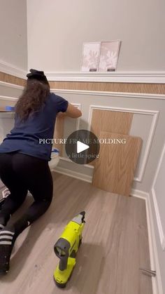 a woman is painting the walls in her house