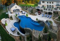 an aerial view of a home with a swimming pool and patio area in the foreground