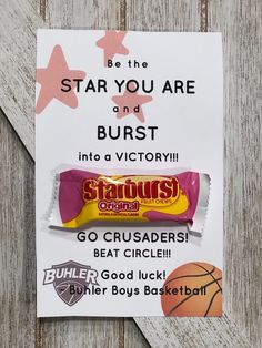 an advertisement for star you are and burst candy bar on a wooden background with pink stars