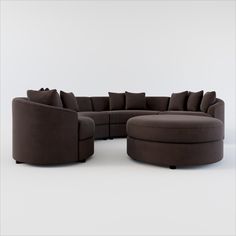 a large sectional couch with pillows on it's back and foot rest in the middle