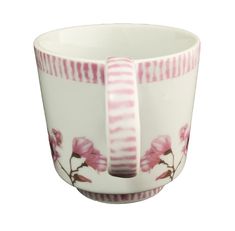 a white and pink flowered cup with stripes on the rim, in front of a white background