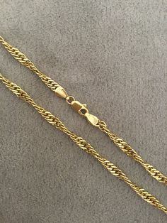 Solid twisted gold curb linked chain. This 18 inch long chain has a double link with a twisted link and is secured with a strong lobster catch. Made in London, England in the 1990's from 9k yellow gold. The chain is in very good condition. Gift Wheat Link Rope Chain Necklace, Classic Rope Chain Link Necklace, Elegant Cuban Link Rope Chain Necklace, Gold Link Rope Chain Necklace Perfect For Gift, Gold Jewelry With Oval Link Rope Chain, Classic Link Chain Necklace With Rope Detail, Gold Link Rope Chain Necklace For Gift, Rope Chain Necklace With Curb Chain For Gift, Elegant Rope Chain Jewelry In Cuban Link Style