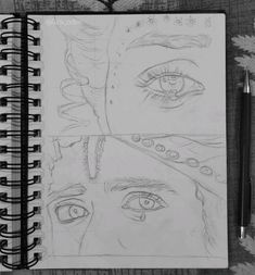 a drawing of two different eyes on a notebook