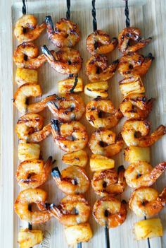 grilled shrimp and pineapple skewers on a tray