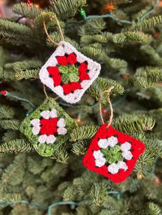 two crocheted ornaments hanging from a christmas tree