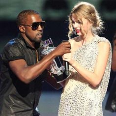 a man and woman standing next to each other on stage with microphones in their hands