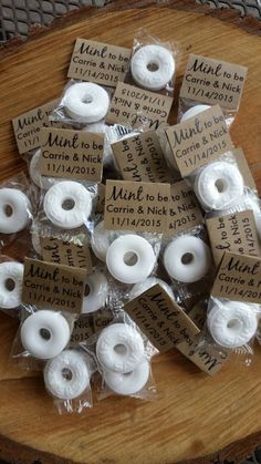 small white donuts wrapped in plastic wrappers on a wooden board with price tags