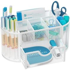 a white desk organizer with pens, scissors and other office supplies in it's holder