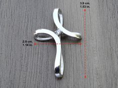 Cross pendant made from Sterling Silver .925 Modern design with a cubic zirconia gemstone in the middle of the cross. Perfect gift choice. DIMENSIONS: Height - 3,9 cm Width - 2,9 cm Weight - approx. 1-2 gr. The item is stamped/marked .925! 100% guaranteed quality. Images are real and not processed with Photoshop. All of this can be seen in the photos. NOTE: Due to the difference device/monitors being used, pictures may not reflect the actual colour of the item. Copyright infringement is prohibit Silver Diamond Cross Necklace For Anniversary, Cubic Zirconia Cross Jewelry For Anniversary, White Gold Cubic Zirconia Cross Necklace For Anniversary, Anniversary White Gold Cubic Zirconia Cross Necklace, Gift Cross Necklace With Diamond Accents In Cubic Zirconia, Diamond White Sterling Silver Cross Necklace As Gift, Elegant Silver Cross Necklace With Cubic Zirconia, Gift Diamond White Sterling Silver Cross Necklace, Silver Cross Necklace With Cubic Zirconia Diamond Accents