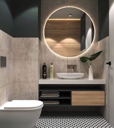 a modern bathroom with black and white flooring, round mirror above the sink and toilet