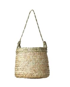 a woven basket hanging from a rope on a white background with the handle down to it's side