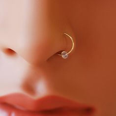 a close up view of a woman's nose with an ear piercing